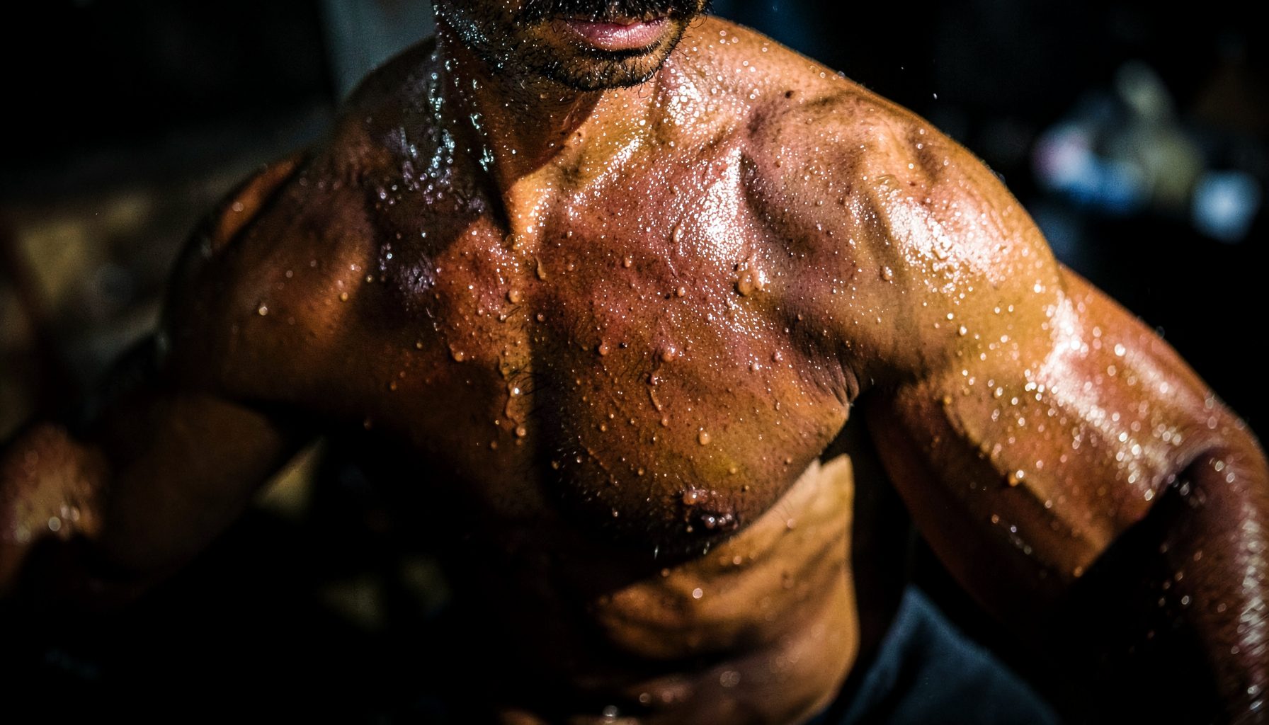 Sweat-sheened bodies, high-contrast lighting, intense physical exertion mood