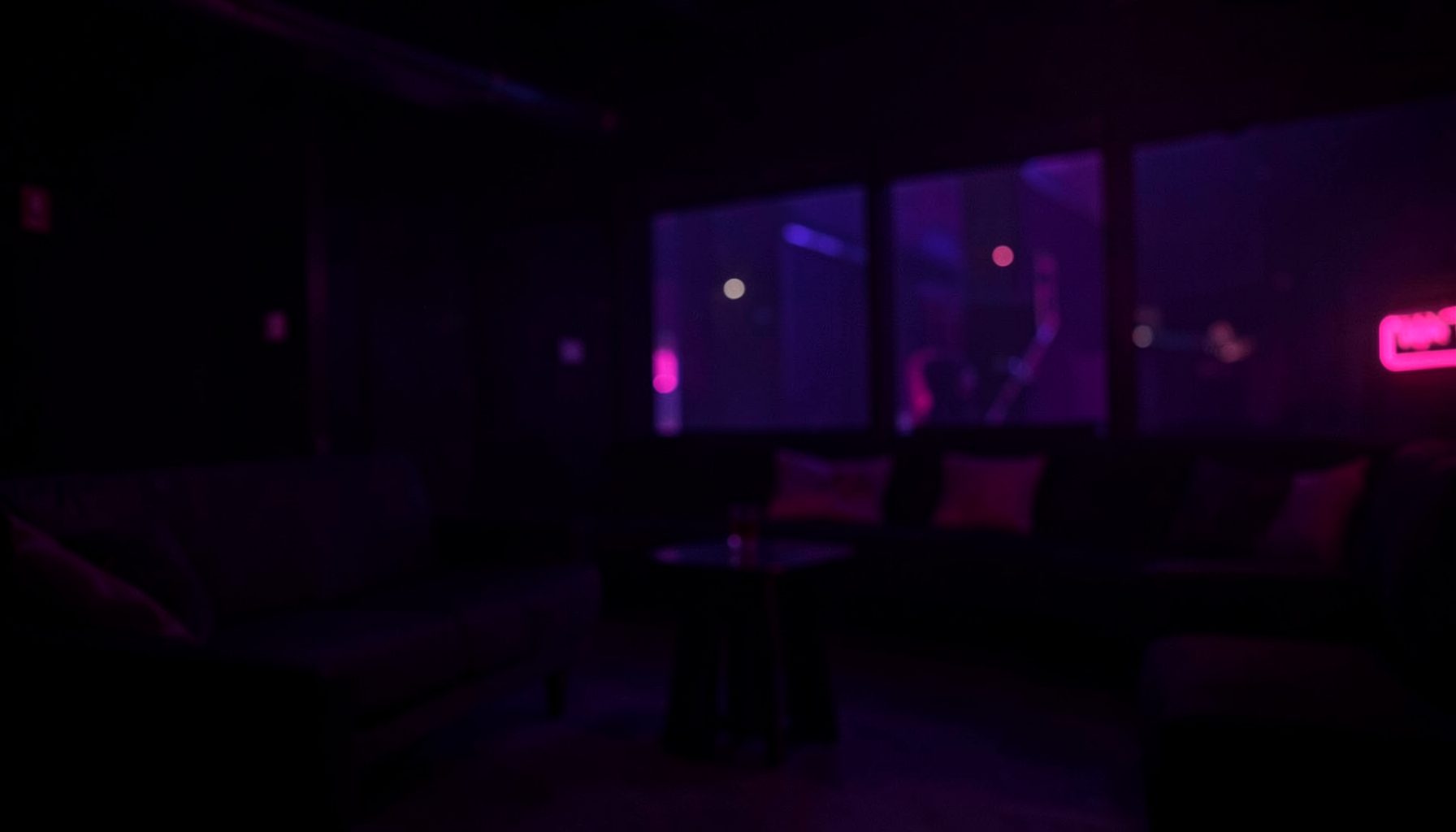 Dark atmospheric backdrop with deep purple and black tones, subtle neon pink glow, evoking a moody late-night digital lounge